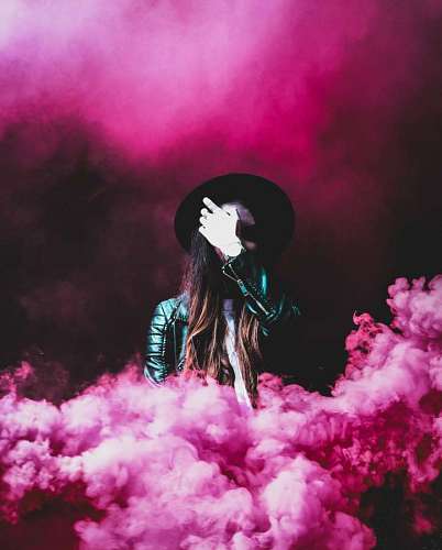 Mulher em fundo rosa de fumo